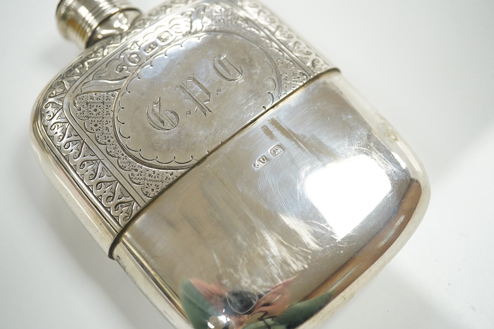 A Victorian silver pocket flask with cup base, maker George Unite, Birmingham 1865, gross 5 oz, and an unmarked Victorian white metal spectacles case. Condition - good